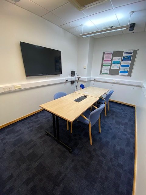 Study room with table, 3 chairs and presentation screen